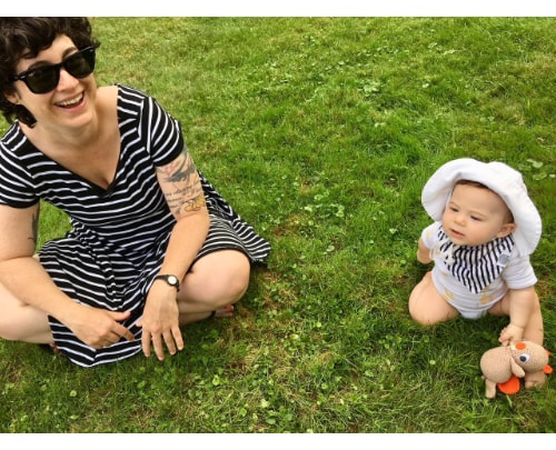 Photo of Laura Mauldin with baby outdoors.